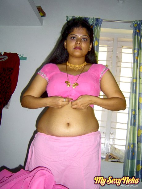 Plump Indian girl Neha gets totally naked on her bed in solo action