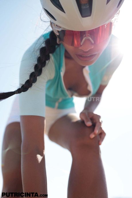 Petite Indonesian cyclist Putri Cinta strips while showing her tits outdoors - Photo 6