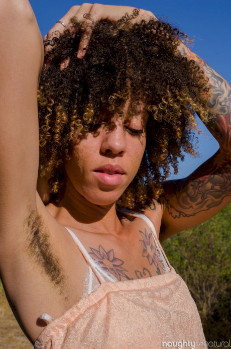 Exotic ebony Kendi Oh unveils her hairy tattooed body in nature