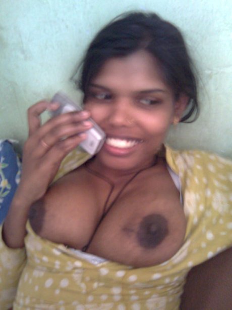 Indian woman exposes her large boobs and upskirt panties in bedroom