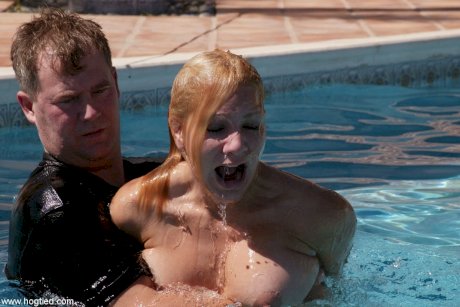 Thick redhead is hogtied in a swimming pool before being freed - Photo 13