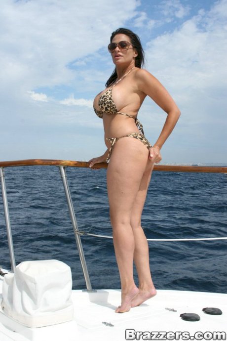 Curvy brunette MILF Ava Lauren poses in a leopard bikini on a yacht