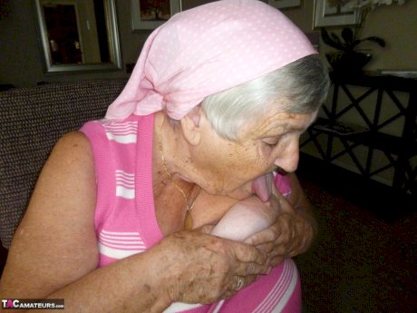 Obese grandmother licks her own nipples as she strips naked in living room
