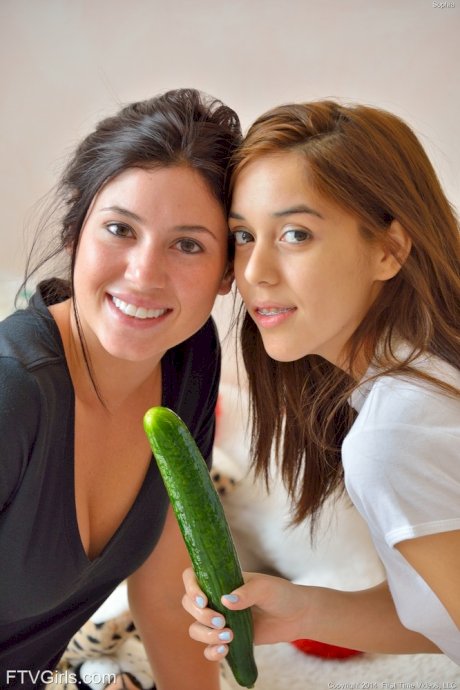 Barely legal lesbians with perky tits insert cucumbers into horny cunts