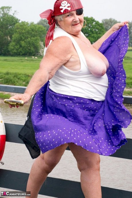 Fat British granny exposes herself on a bridge while sporting pirate attire