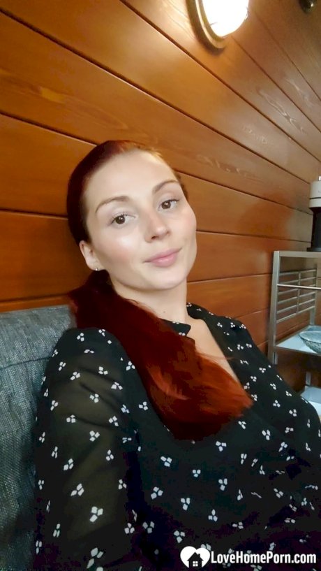 Gorgeous redhead shows off her big tits & her tattoos while taking nudes