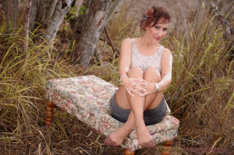 Mature pinup model Roni Ford kicks off pumps wearing retro lingerie in woods - Photo 6