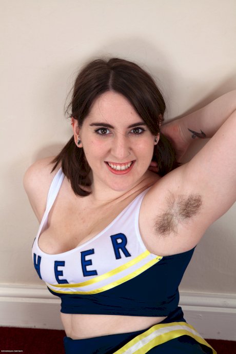 Chubby cheerleader Beryl Aspen unveils her big tits and furry vagina