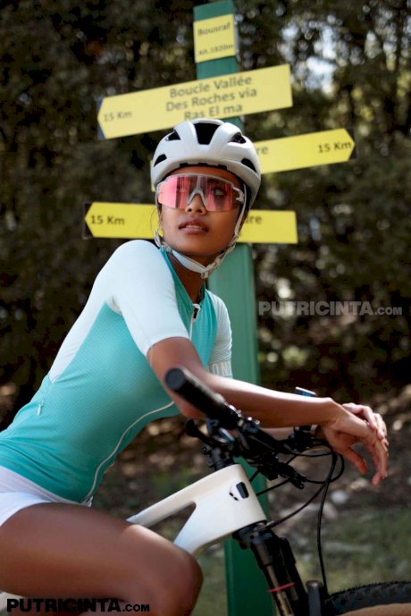Petite Indonesian cyclist Putri Cinta strips while showing her tits outdoors - Photo 11