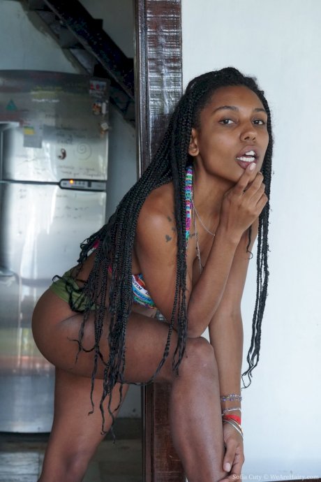 Afro-American beauty Sofia Cuty shows her big boobs & bushy twat as she strips