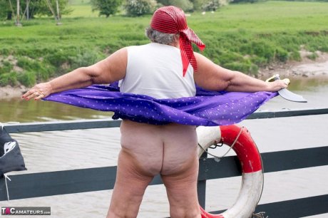 Fat British granny exposes herself on a bridge while sporting pirate attire