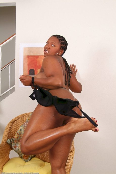 Black amateur with a big butt and natural tits gets totally naked on a chair - Photo 8