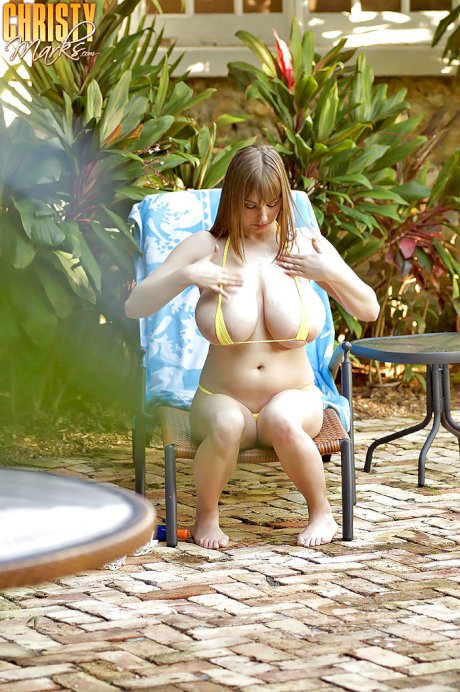 Leggy Christy Marks freeing huge natural tits and ass from bikini outdoors