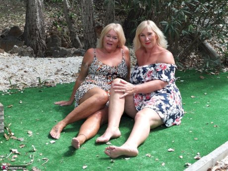 Mature woman Melody and her lesbian lover fondle each others boobs outdoors