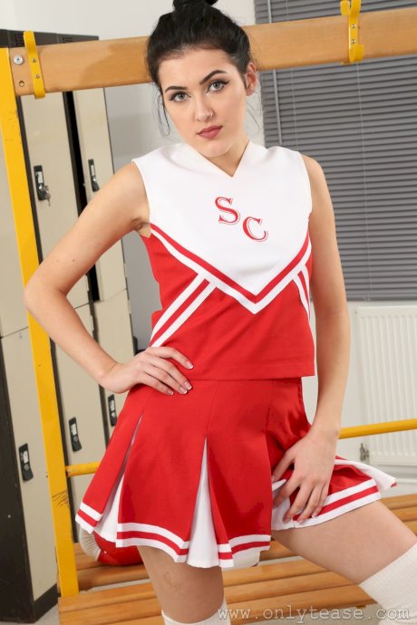 Black haired cheerleader Maryanna doffs her uniform and poses in locker room