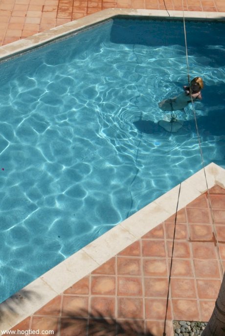 Thick redhead is hogtied in a swimming pool before being freed - Photo 9
