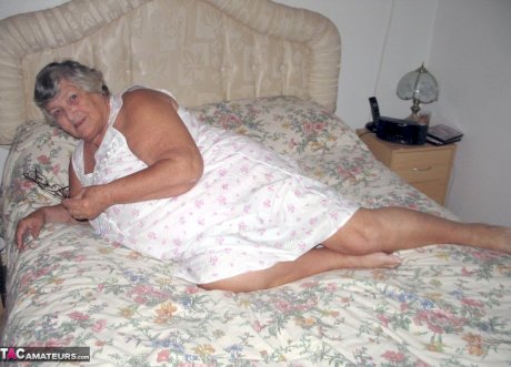 Old woman Grandma Libby grabs her fat roll after getting naked on a bed