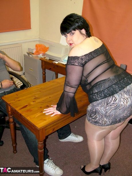 Dark-haired BBW Double Dee sucks a cock before being banged over a table