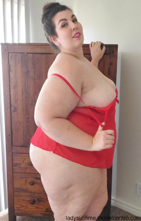 Fatty in a red negligee Lady Sublime flaunts her big juggs while sucking a toy