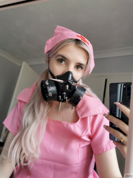 Naughty Quarantine Challenge sheds her nurse costume & poses in a gas mask