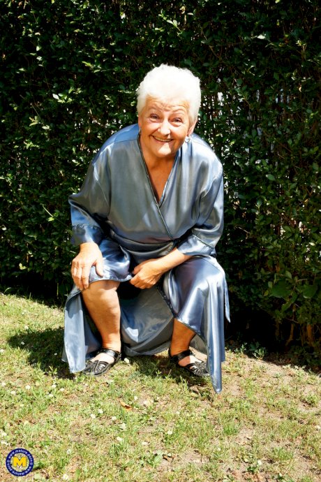 Crazy old granny Vera D drops her robe and masturbates in the back yard
