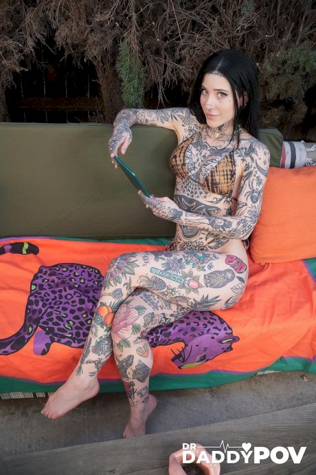 Tattooed brunette has POV sex with a large cock on a red sofa - Photo 1