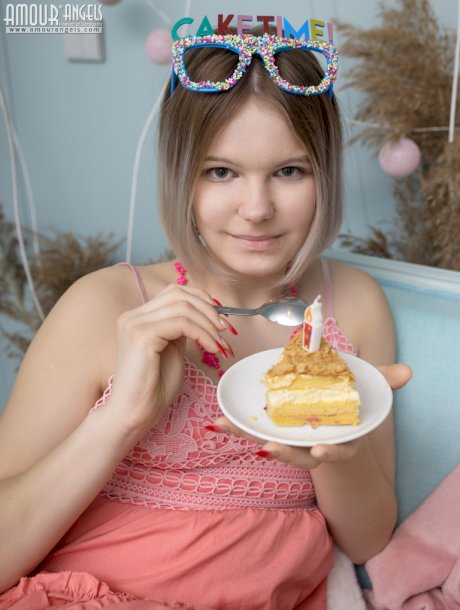 Lovable teen cutie treats herself to a tasty piece of cake and treats you to