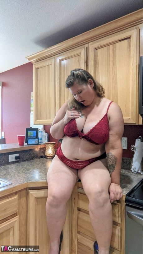 Amateur woman Busty Kris Ann shows her big tits and butt in her kitchen