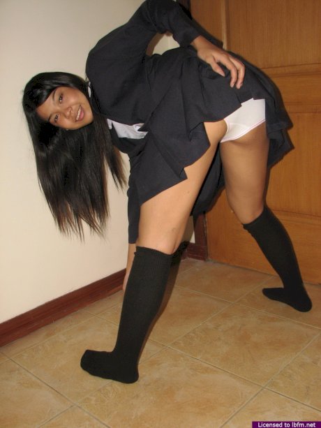 Asian schoolgirl slips off cotton underwear for nude solo poses in black socks