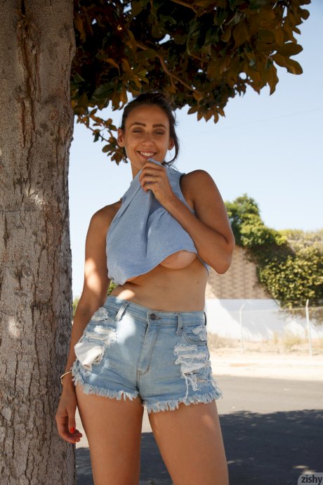 Stunner with big tits Rhonda Biasi posing braless in sexy shirt & shorts