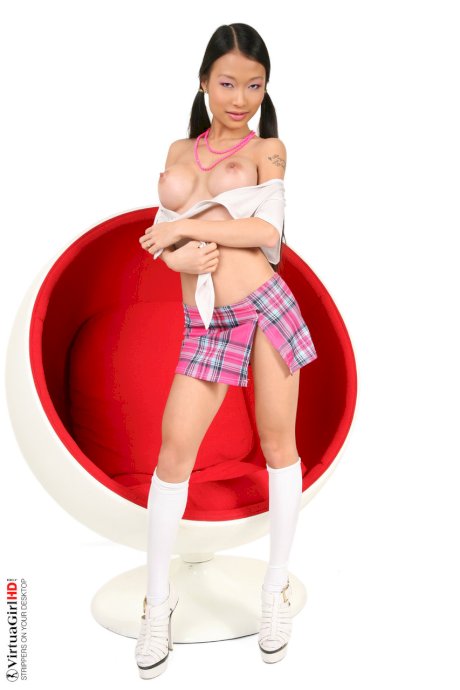 Cute Asian schoolgirl Pussykat gets naked on an egg chair in socks and heels