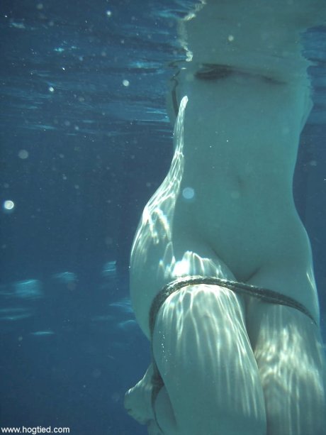 Thick redhead is hogtied in a swimming pool before being freed - Photo 20