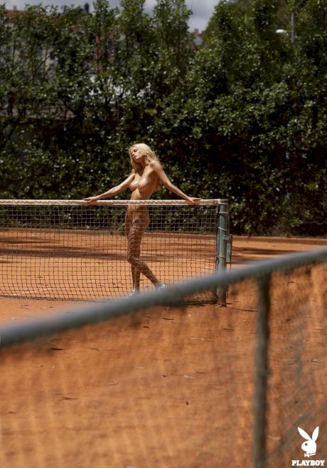 Blonde Playboy muse Olga De Mar flashes her exotic boobs on the tennis court