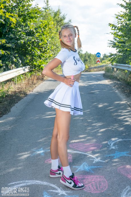Blonde teen Nana strips to her socks and runners on a paved road