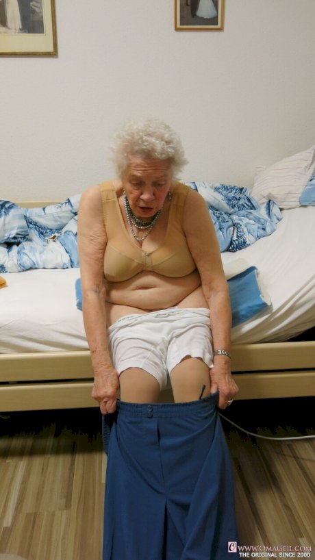 Kinky old granny Ornella poses naked and teases with her huge juggs