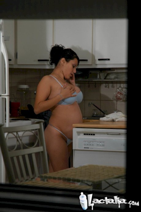 Pregnant Latina female plays with her big tits and pussy in the kitchen