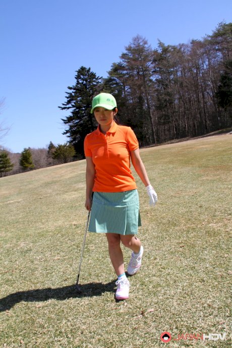 Japanese woman Nana Kunimi lifts up her skirt while on a golf course porn pics
