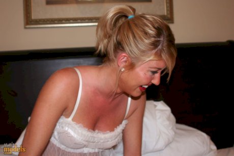 Naked blonde with firm tits changes into lingerie to smoke on balcony