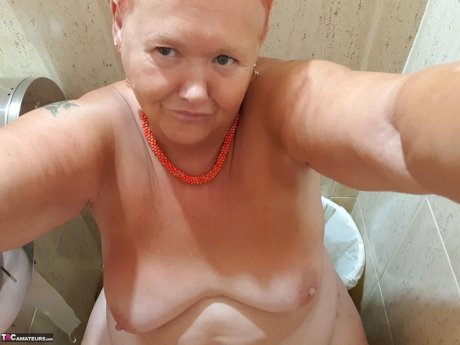 Fat granny with red hair Valgasmic Exposed takes naked selfies at home