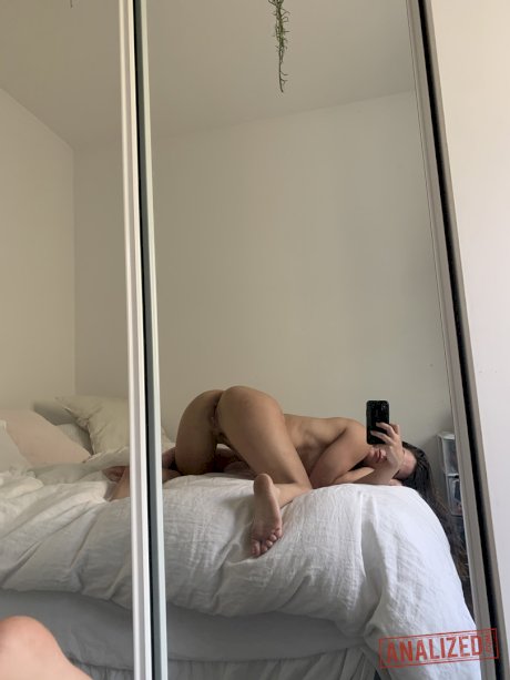 Amateur model holds her bare ass during a series of nude selfies