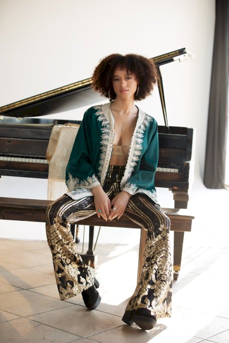 Ebony centerfold model Stormi Maya gets naked in boots on a piano bench