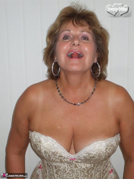 Older amateur Busty Bliss releases her big natural tits from a laced corset