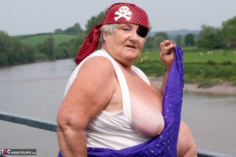 Fat British granny exposes herself on a bridge while sporting pirate attire