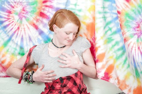 Redhead punk chick Isadora fondles all natural boobs and fingers hairy twat