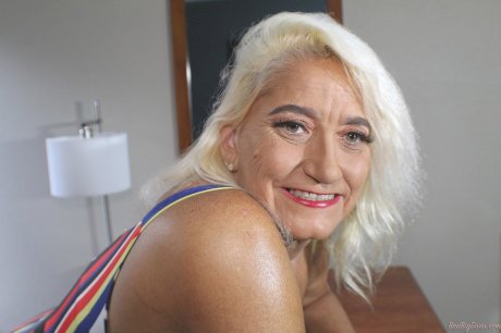 Blonde granny Amber Conners hikes her dress up to show her massive ass