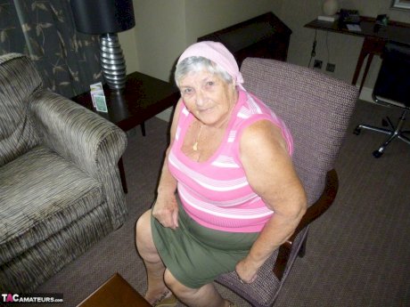 Obese grandmother licks her own nipples as she strips naked in living room
