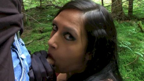Goth woman Lady Angelina sucks the sperm from a big cock near the woods