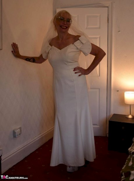 British woman Barby Slut shows her big tits while wearing bridal wear