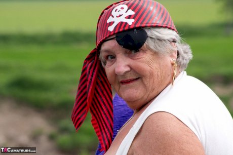 Fat British granny exposes herself on a bridge while sporting pirate attire