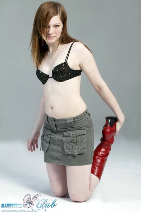 Pale redhead Lilly slowly strips to a black G-string and red leather boots